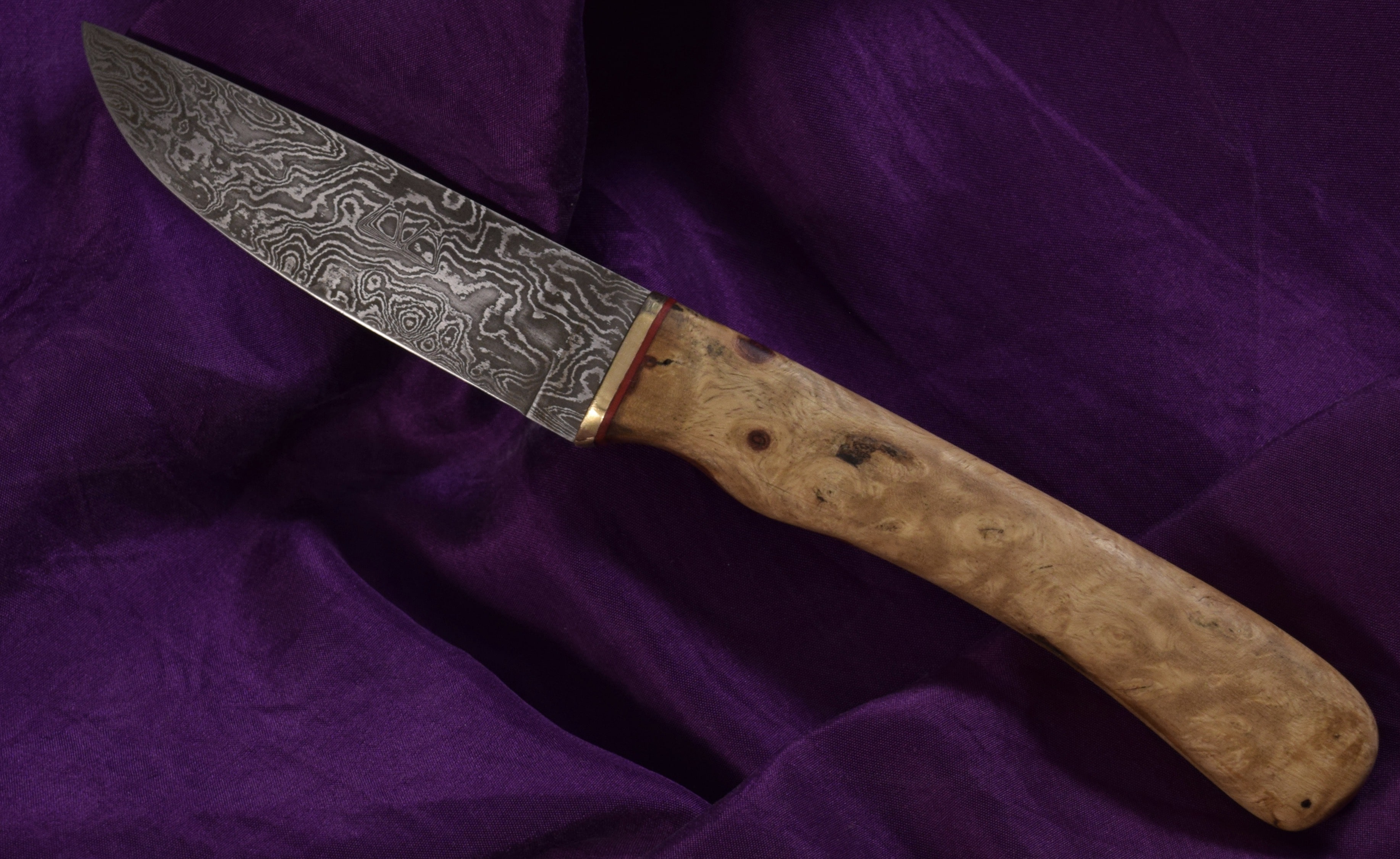 A 192-layer Damascus steel Malachite with an Amboyna burl handle. A 192-layer Damascus steel Malachite with an Amboyna burl handle.