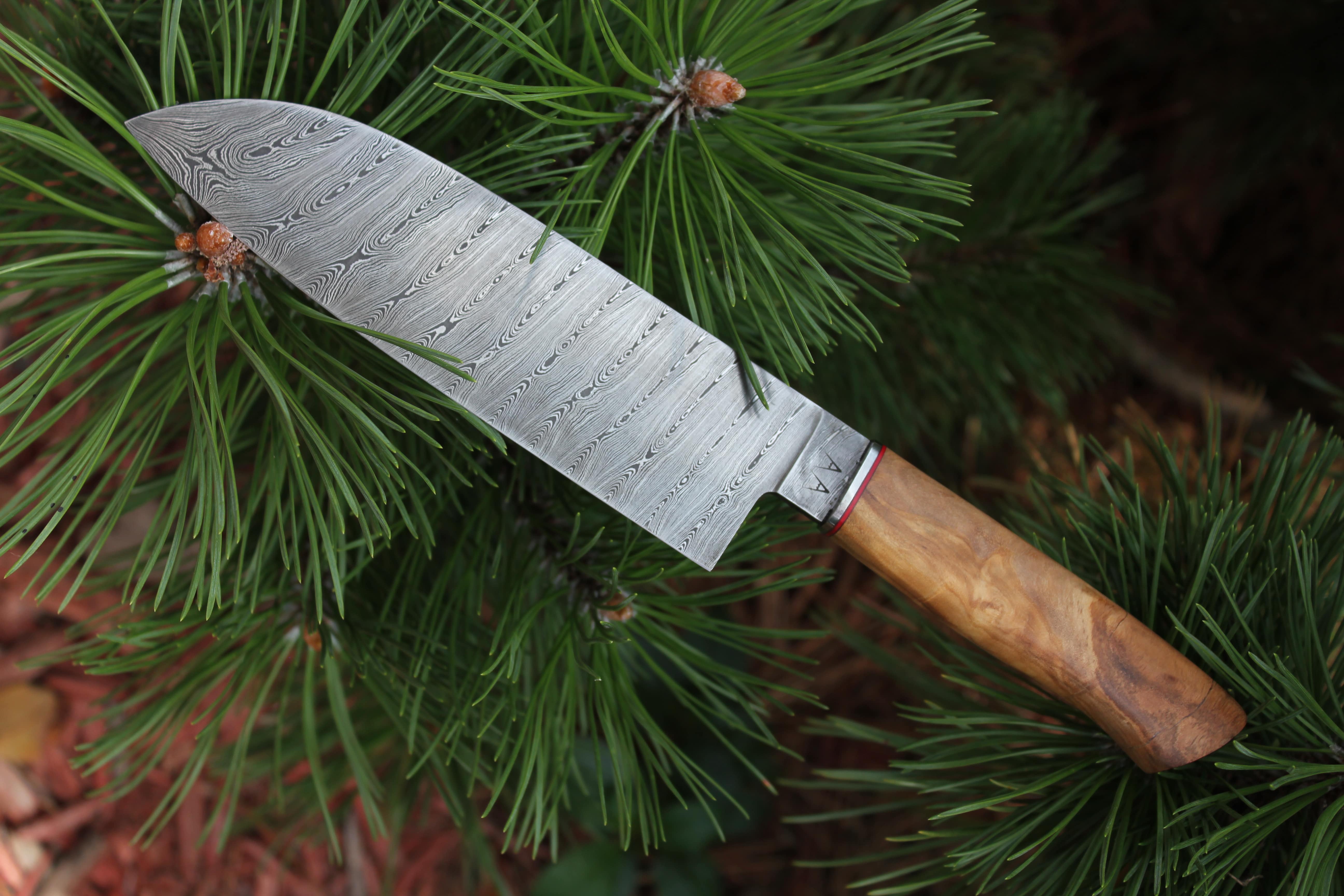 A custom 192-layer Damascus steel santoku with an Olivewood handle. A custom 192-layer Damascus steel santoku with an Olivewood handle.